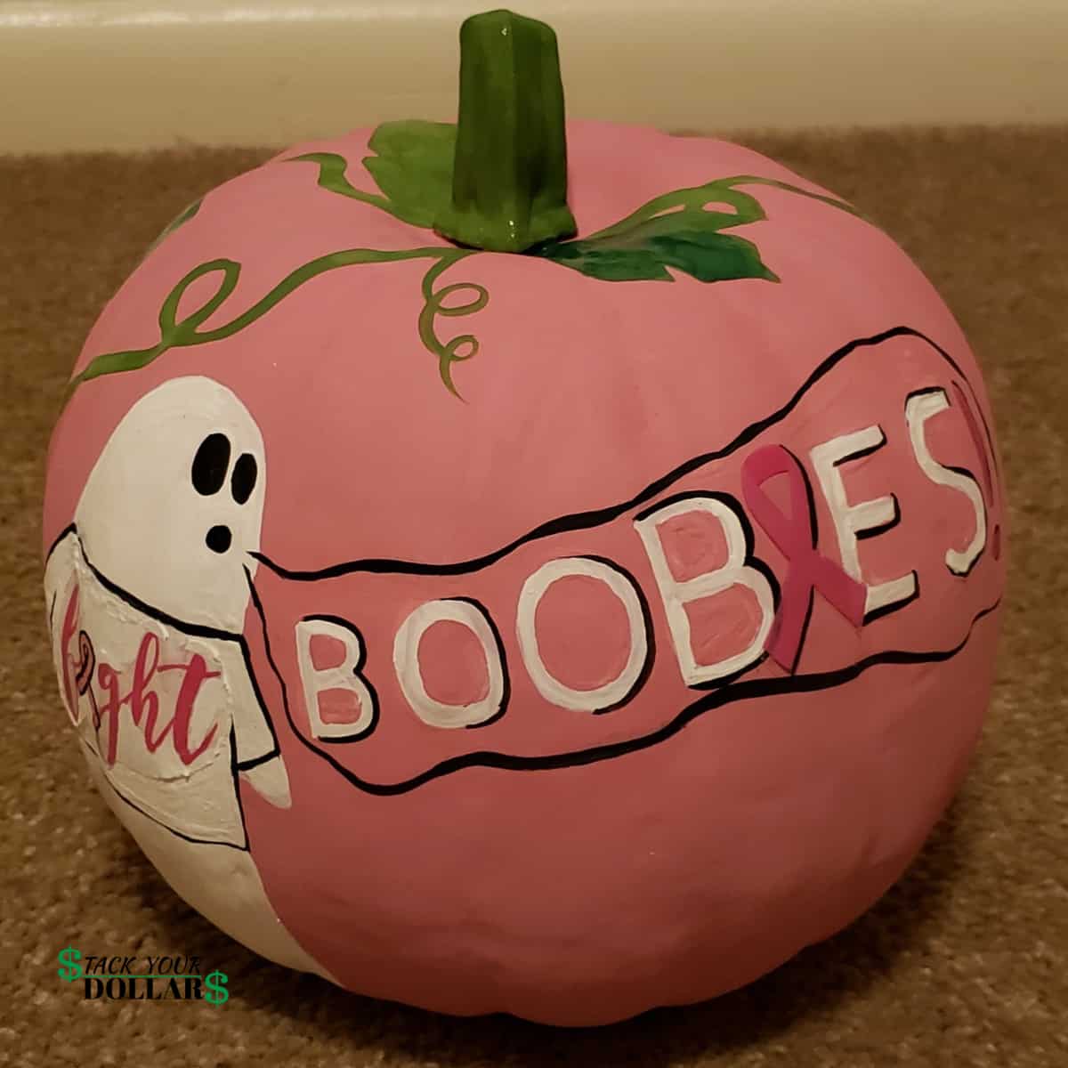 Halloween pumpkin painted pink for Breast Cancer Awareness. A painted ghost saying, "Boobies".