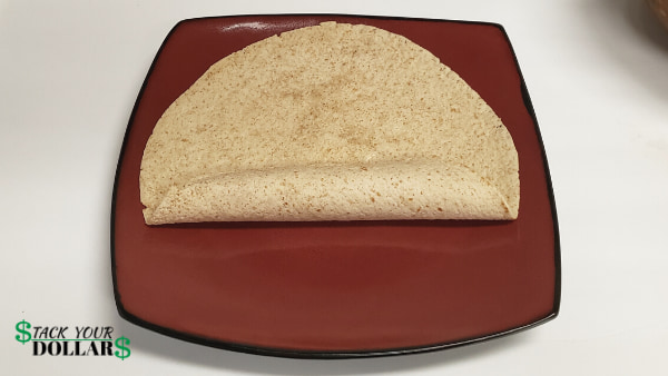 Folding up the bottom of a burrito to wrap