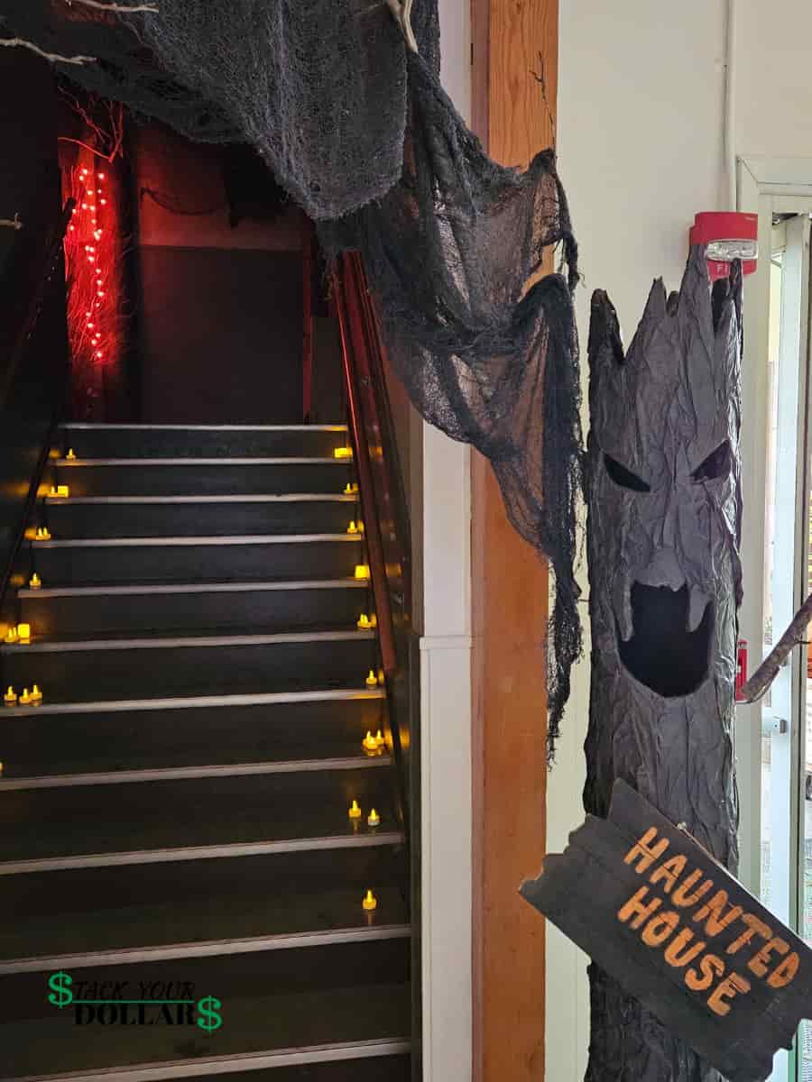 Haunted house entrance with a petrified tree